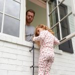 girl on fire escape ladder out of window